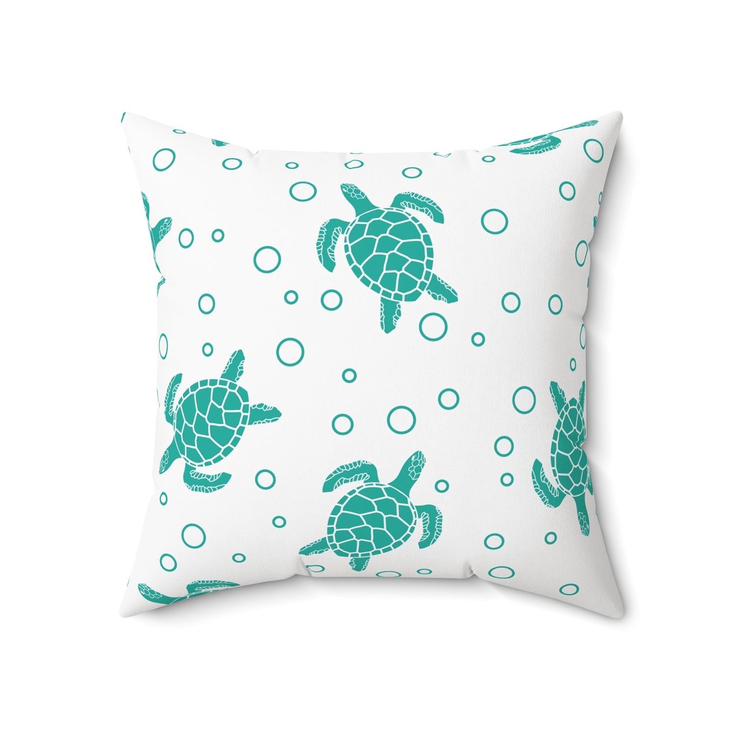 Square decorative pillow showing teal sea turtles and teal ring dots on white cover