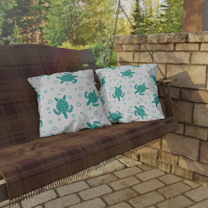 Pair of outdoor sea turtle pillows in white with teal turtles and dot circles
