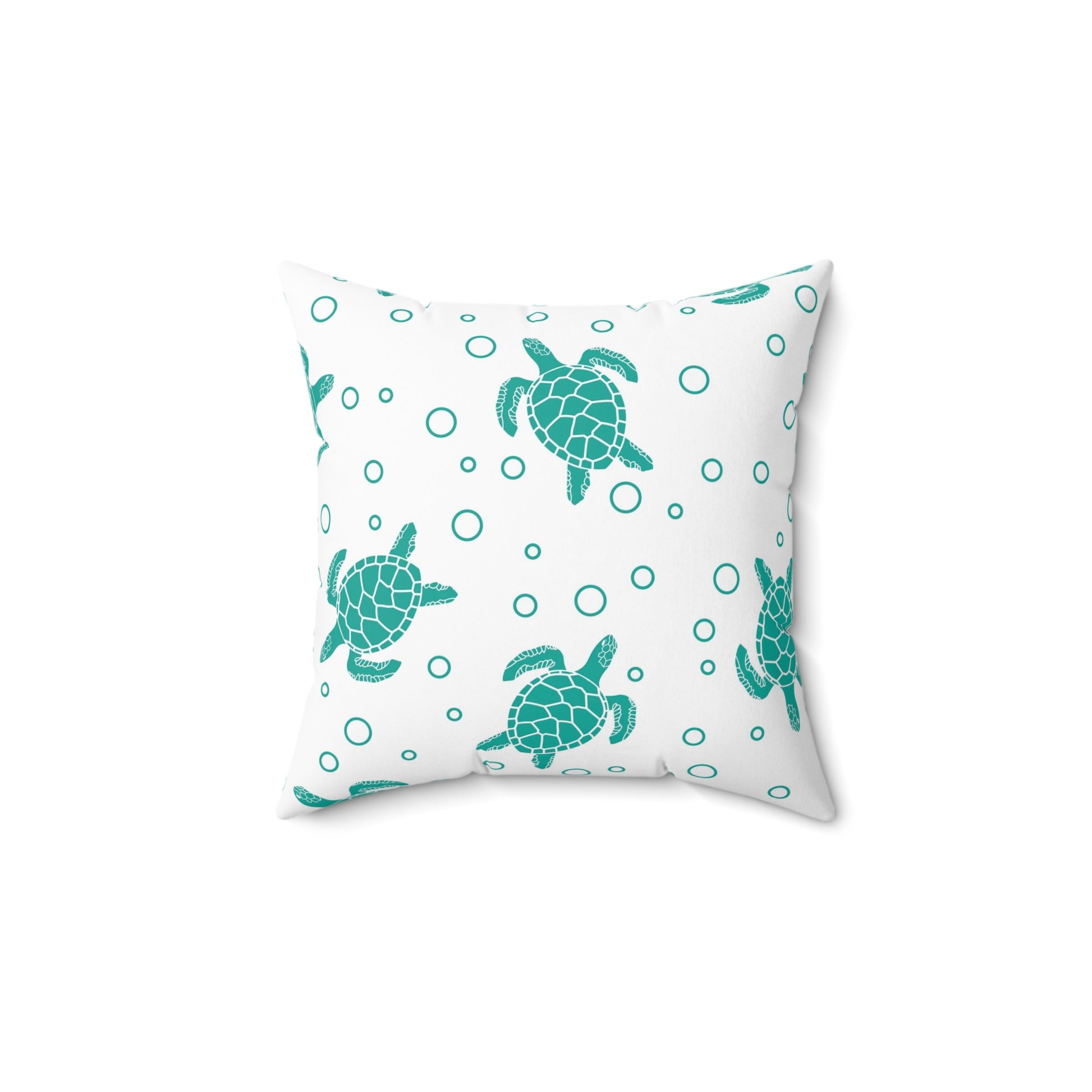 Square decorative pillow with teal sea turtle print and small teal circle accents on white fabric