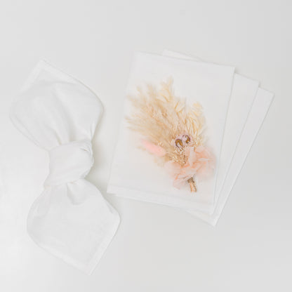Flour sack napkins, white, with a dried-flower accent on one napkin