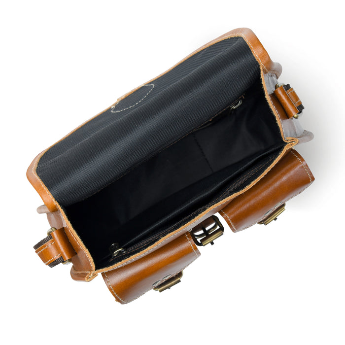 Brown leather sling bag interior view with dark lining and two buckle-strap compartments
