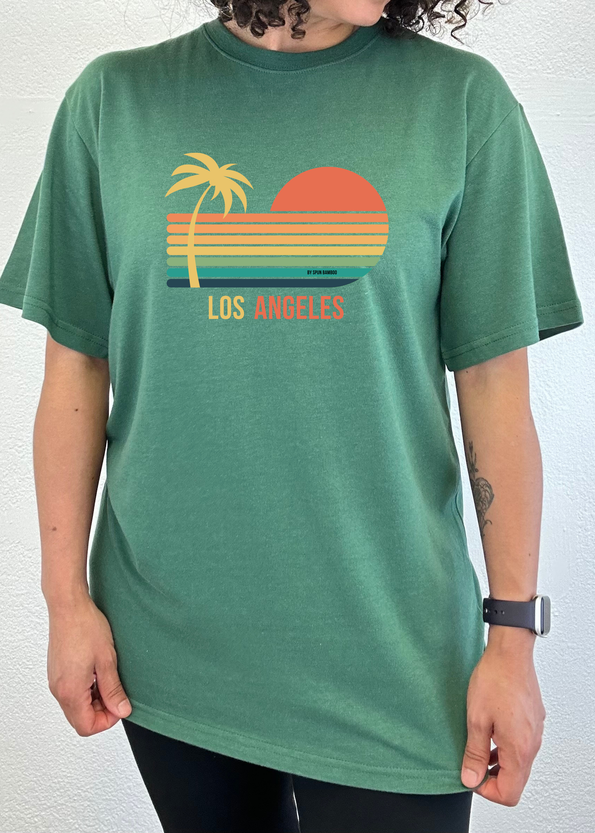 Green unisex graphic short-sleeve T-shirt with palm, sunset, and “Los Angeles” print