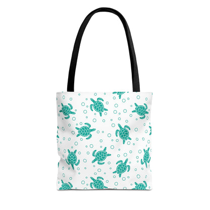Sea turtle pattern tote bag with teal repeating turtles and black carry handles