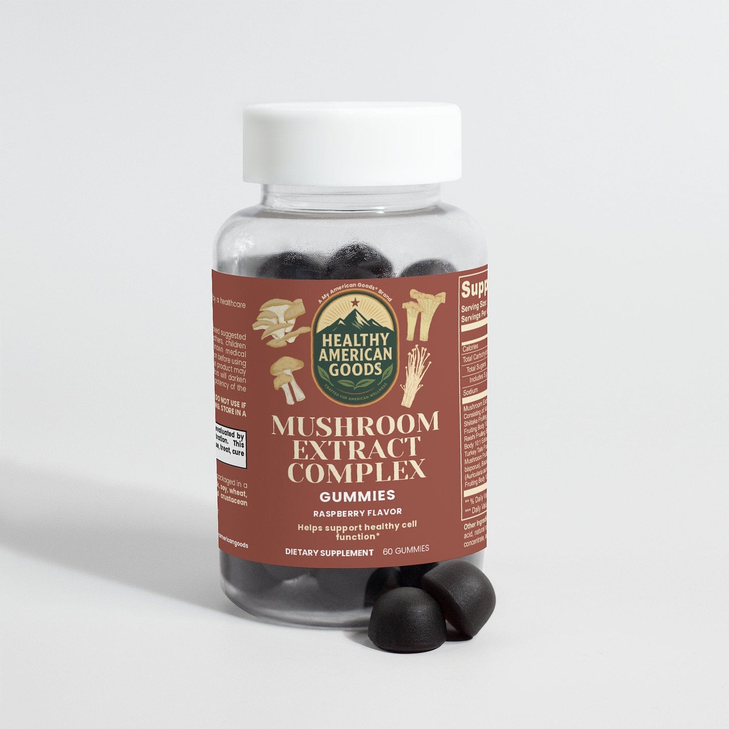 Mushroom extract complex supplement bottle with two dark gummies in front
