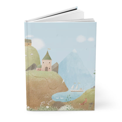 Hardcover journal with countryside cover illustration; pages visible at top