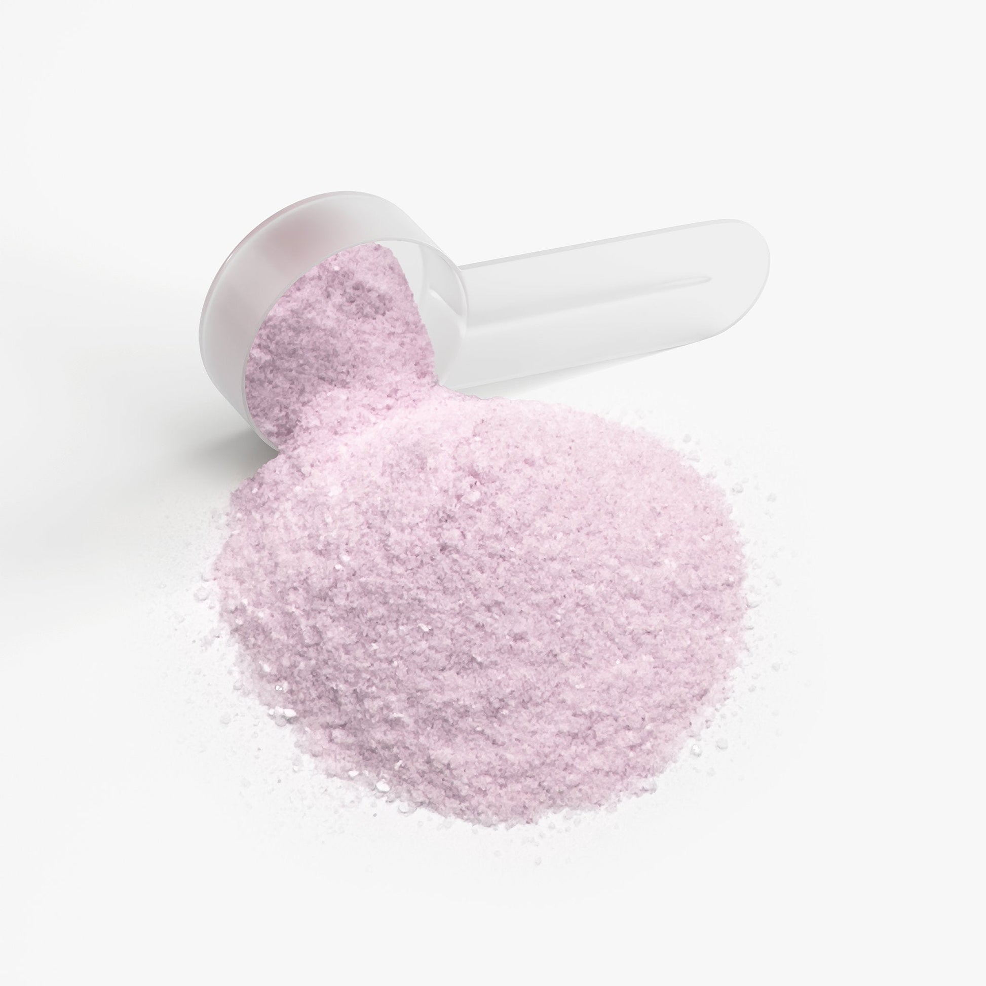 Powder scoop holding light pink supplement powder