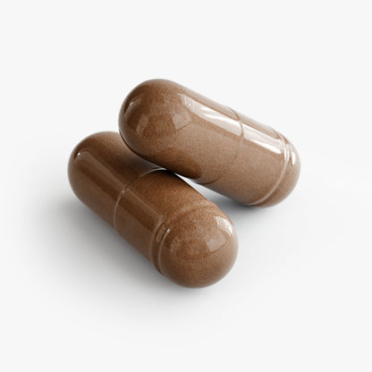 Two brown herbal capsules on a white background
