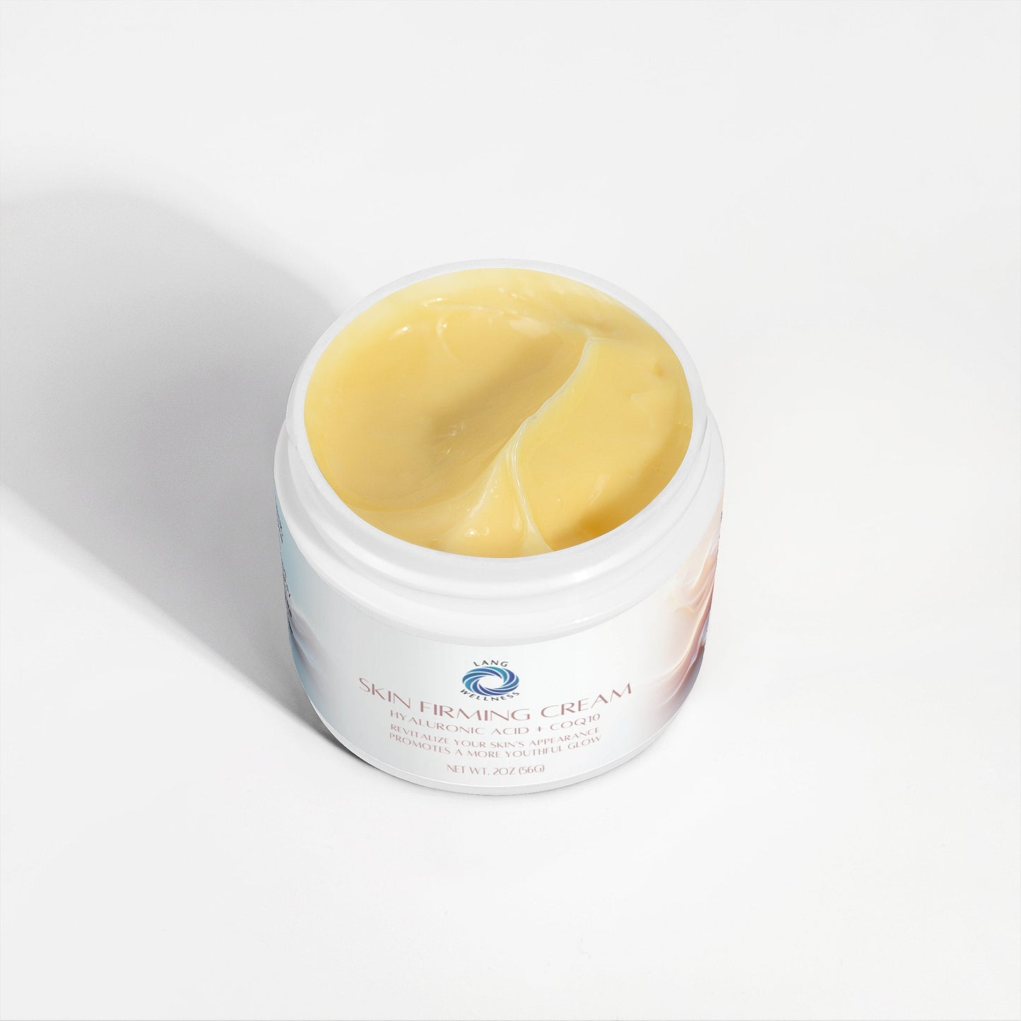 Skin firming cream jar open, showing smooth yellow cream inside