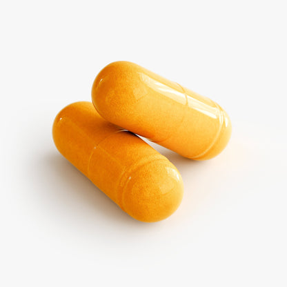 Orange turmeric capsules, two units, oval and glossy