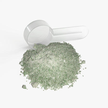 Matcha green tea hydration powder with a white scoop and green pile