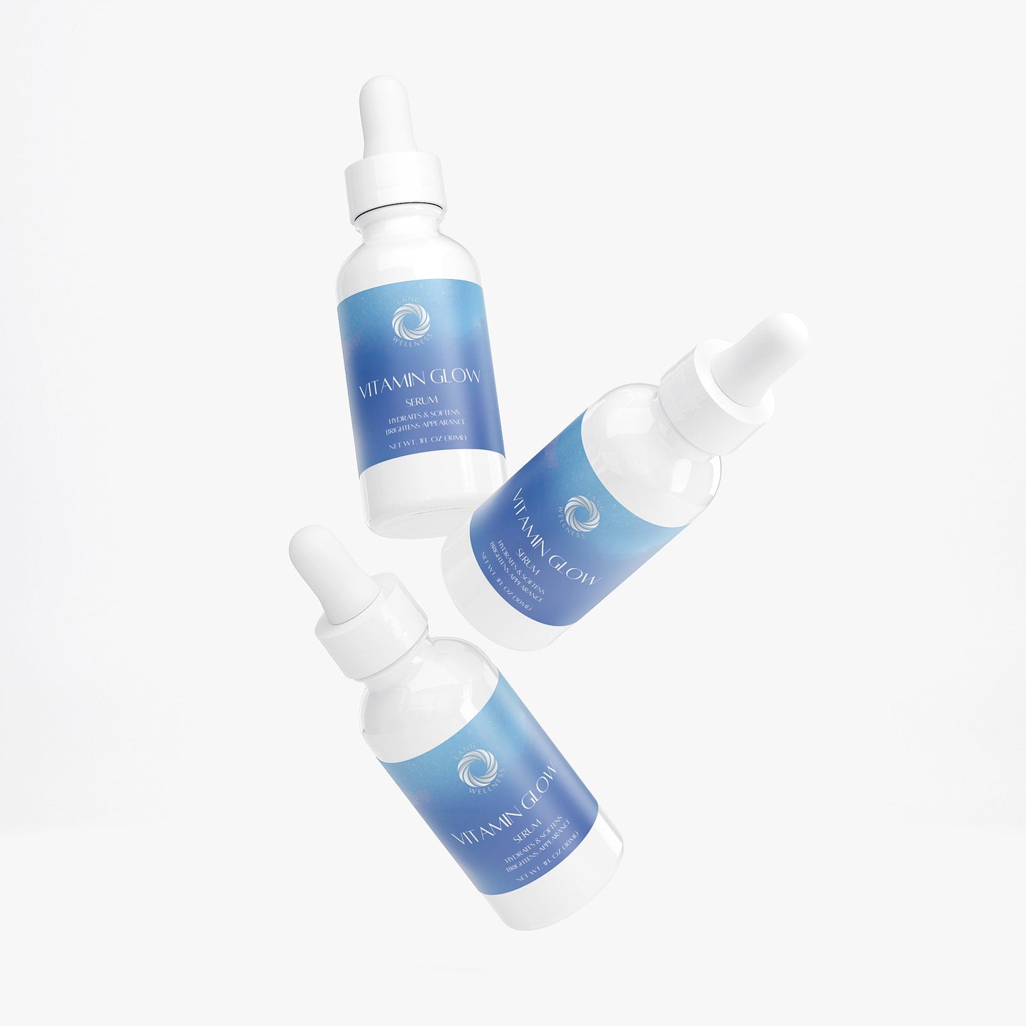 Vitamin glow serum bottles with dropper pipettes, angled arrangement