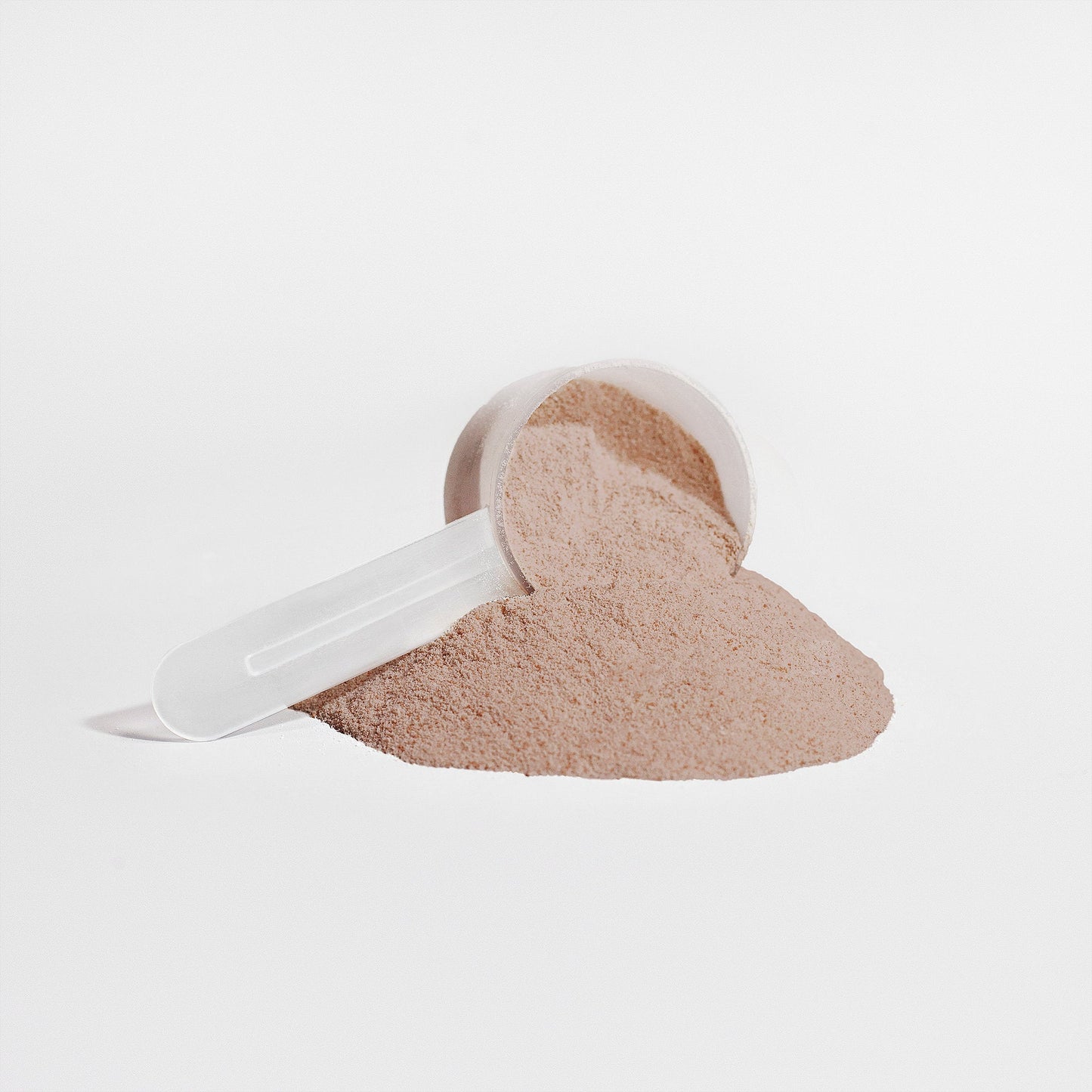 Chocolate plant protein powder scoop and measuring scoop with light beige powder