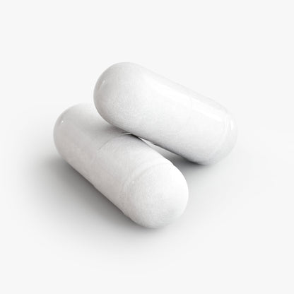 White probiotic capsules, oval pills close-up