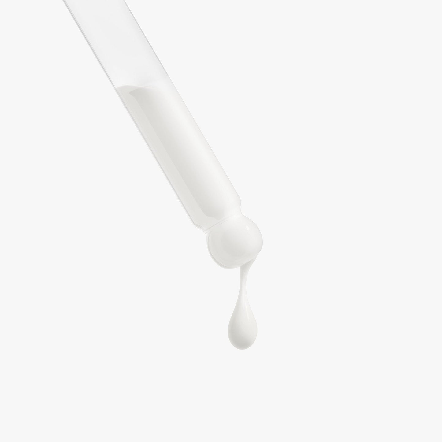 Thick white serum texture dispensing from a dropper tip
