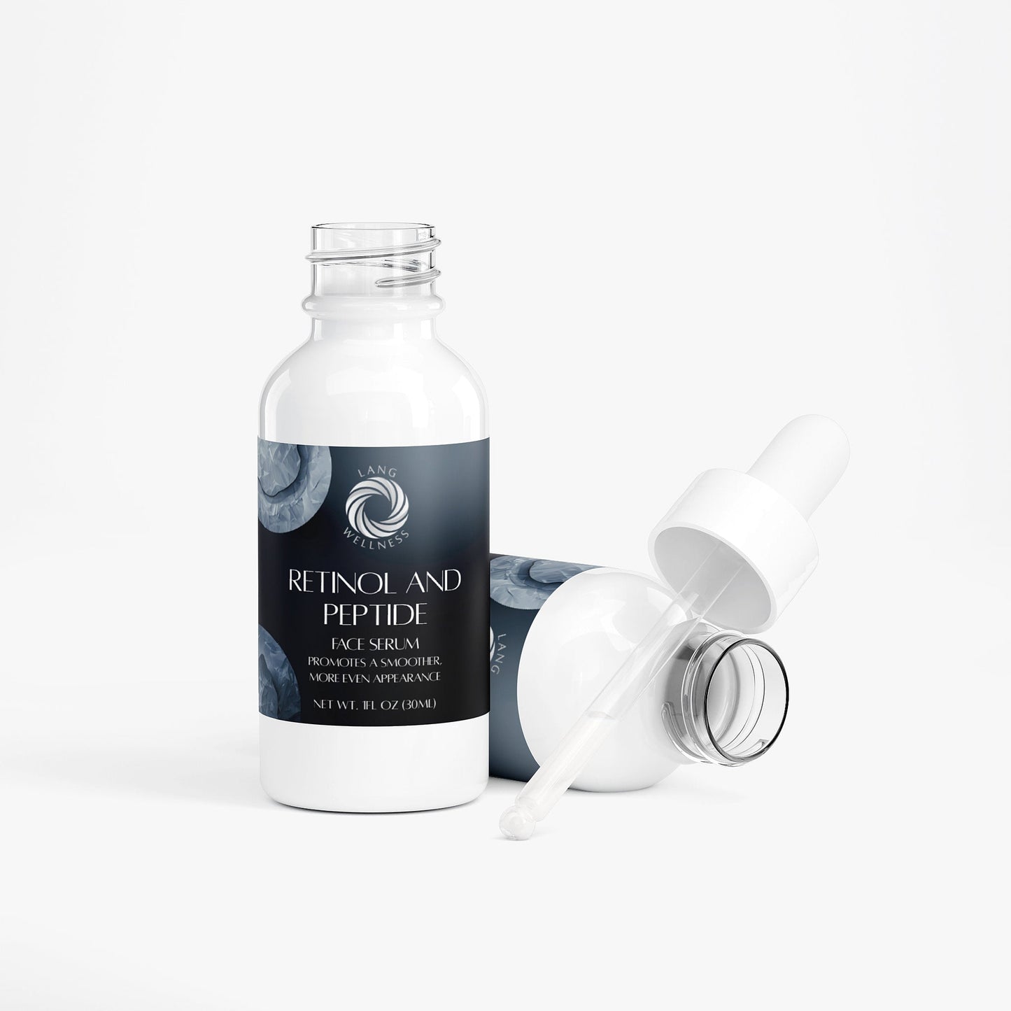 Face serum bottle with detached pump and open cap, studio view