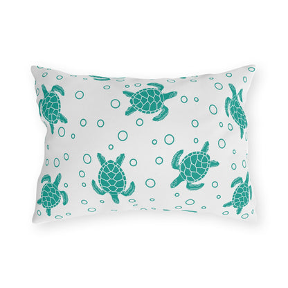 Square outdoor cushion pillow with teal sea turtles and ring-dot pattern on white cloth.
