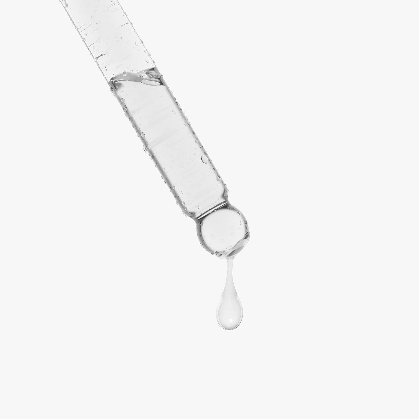 Snail mucin face serum dropper releasing a clear serum droplet