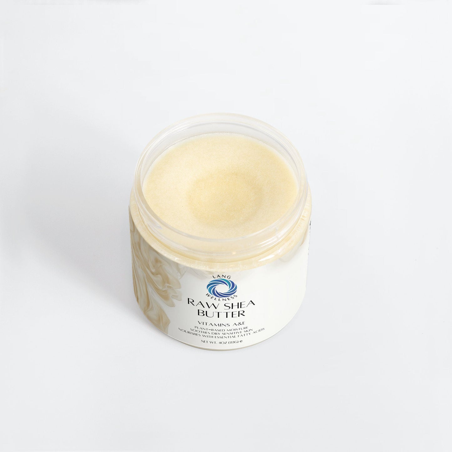 Raw shea butter in clear-lid jar, pale cream surface.
