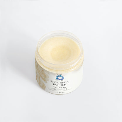 Raw shea butter in clear-lid jar, pale cream surface.
