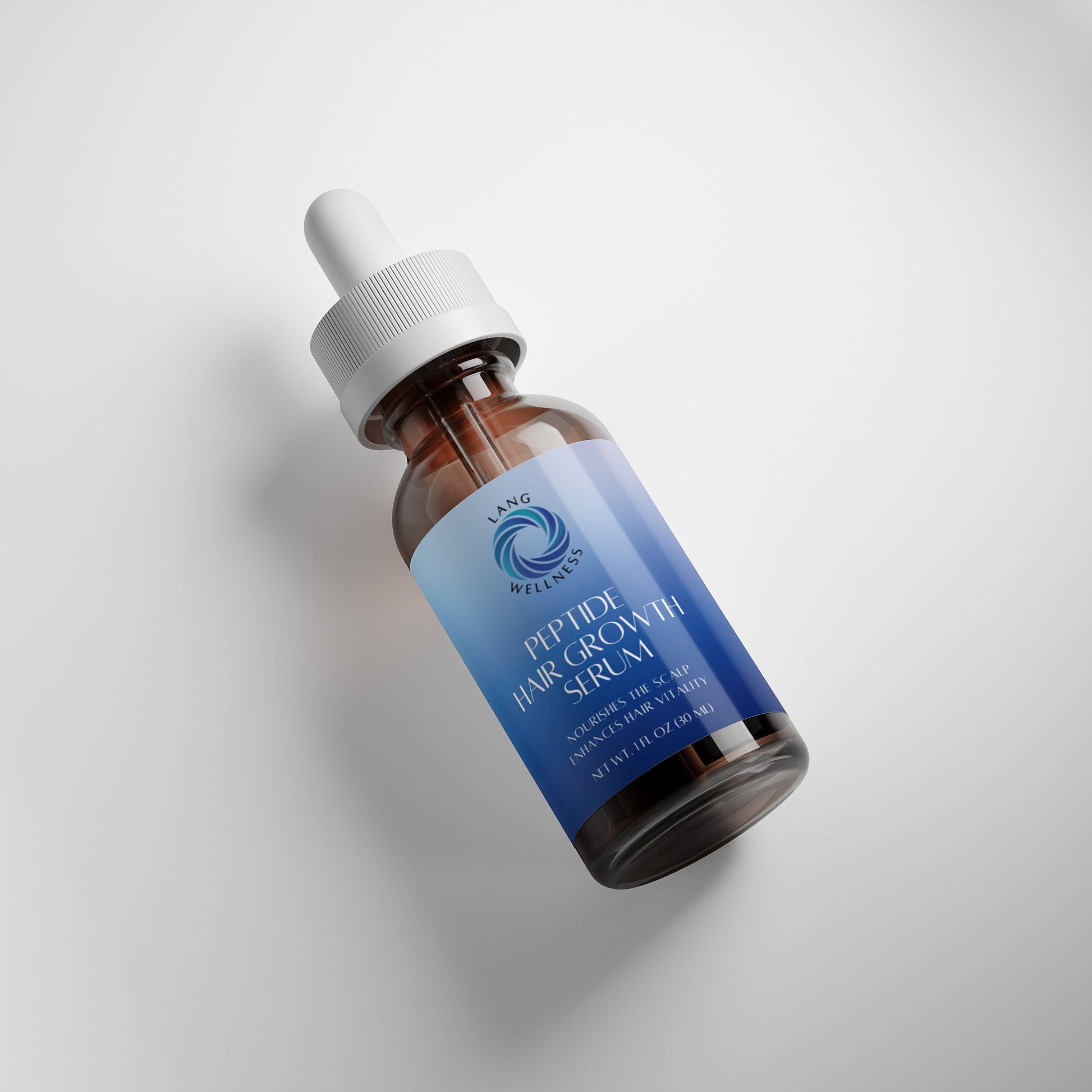 Hair growth serum bottle at angle with white dropper cap, amber glass and blue label