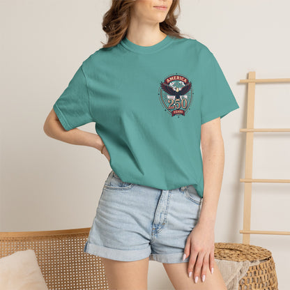 Teal T-shirt worn by model, with round “America 250 Years” emblem on chest