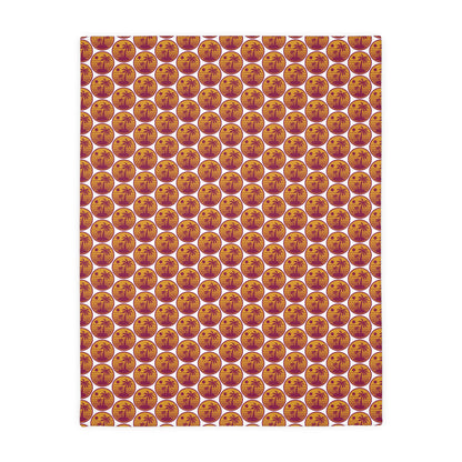 Square throw blanket with repeating pumpkin faces in orange, cream, and gold