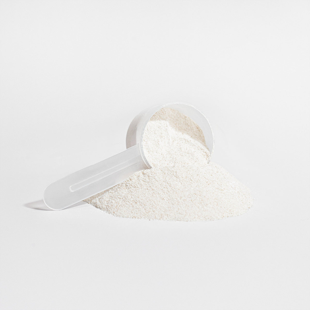 Measuring scoop filled with white collagen powder