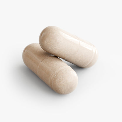 Beige multivitamin capsules lying on a clean background