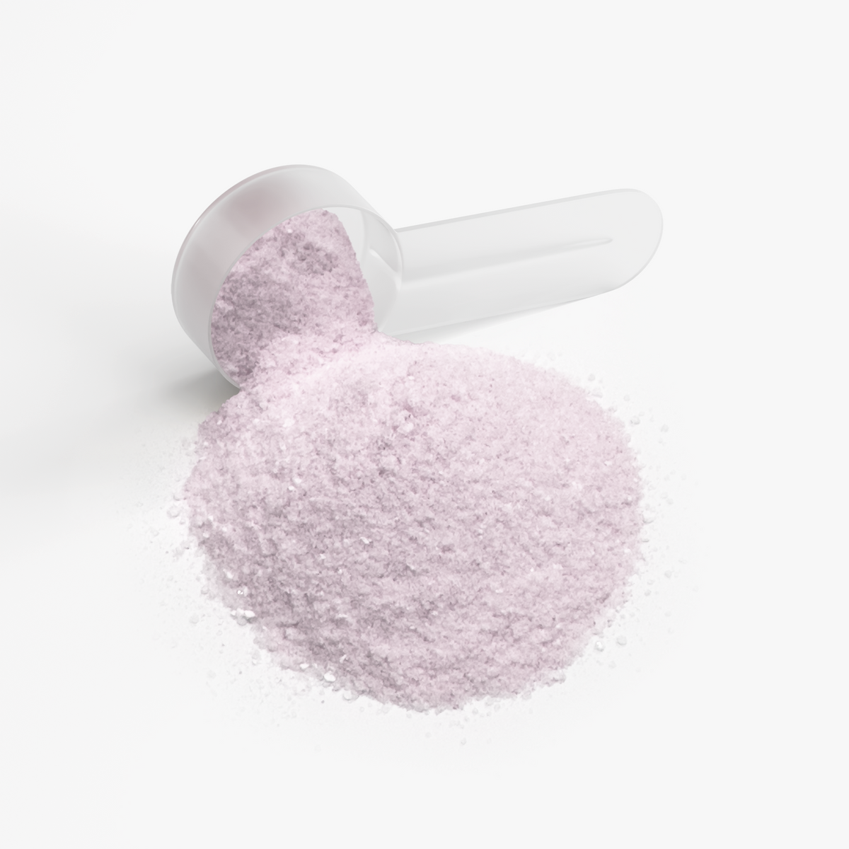 Measuring scoop filled with pale purple energy powder, spilling pile on surface.
