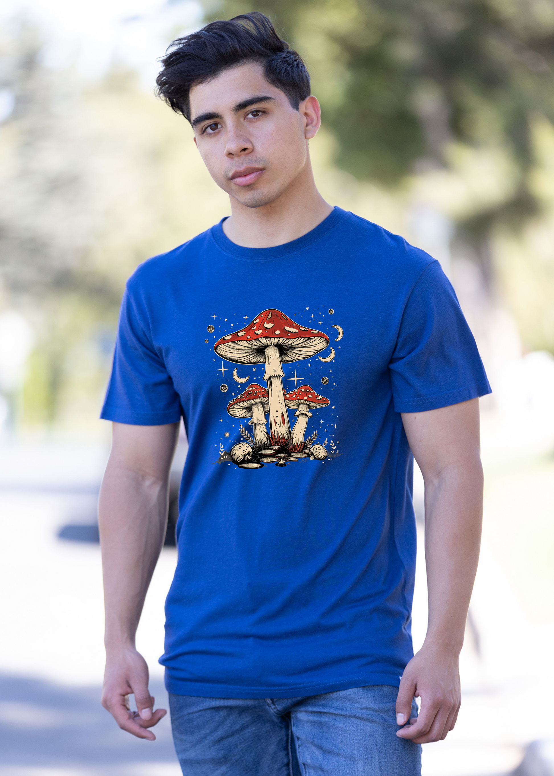 Blue unisex graphic T-shirt with red-capped mushrooms and swirl details, crew neck.