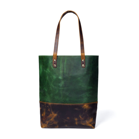 Leather tote bag with green panel, long handles, patterned brown bottom