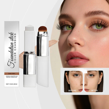 Color-changing foundation stick with brush tip and beige swatch, dark skin tone