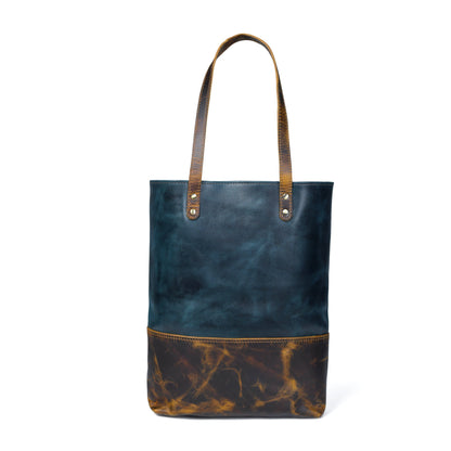 Dark blue leather tote with tan-brown bottom panel and two top carry handles