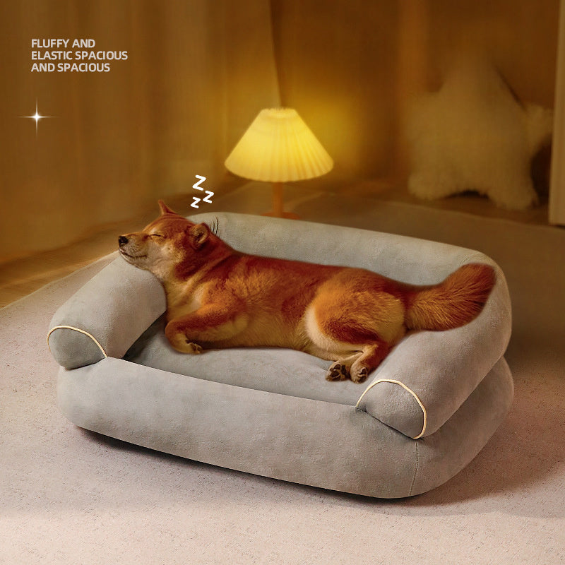 Light gray pet sofa bed with cushioned bolster sides and raised sleeping center.