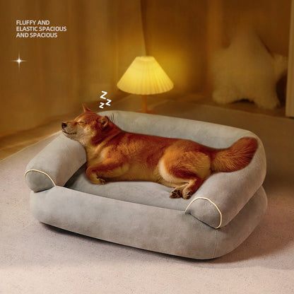 Light gray pet sofa bed with cushioned bolster sides and raised sleeping center.
