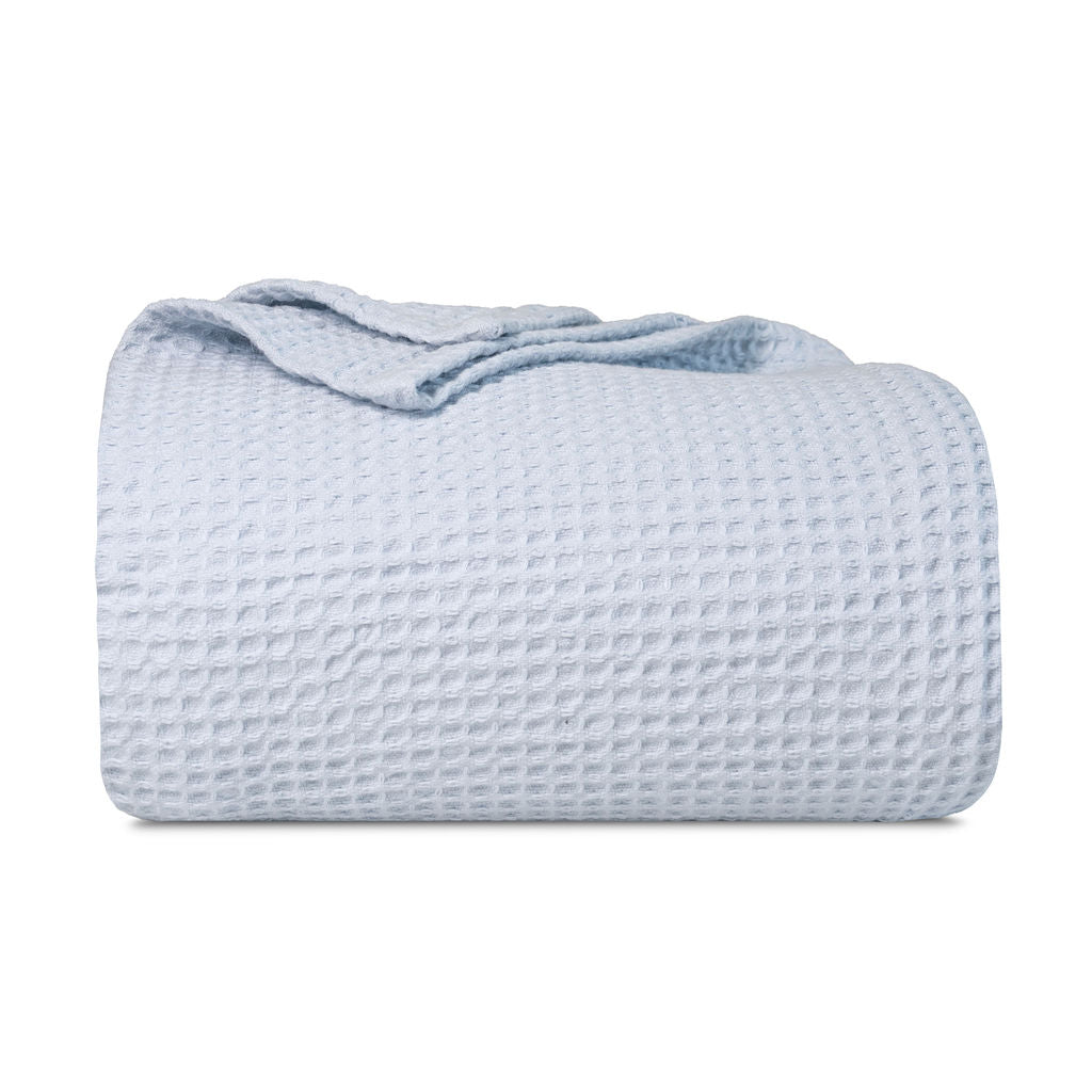 Waffle weave blanket, folded light blue with waffle texture and rolled edge
