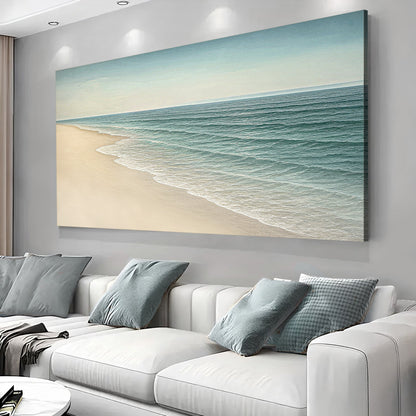 Landscape wall art canvas showing a sandy beach and calm ocean waves in teal and beige.