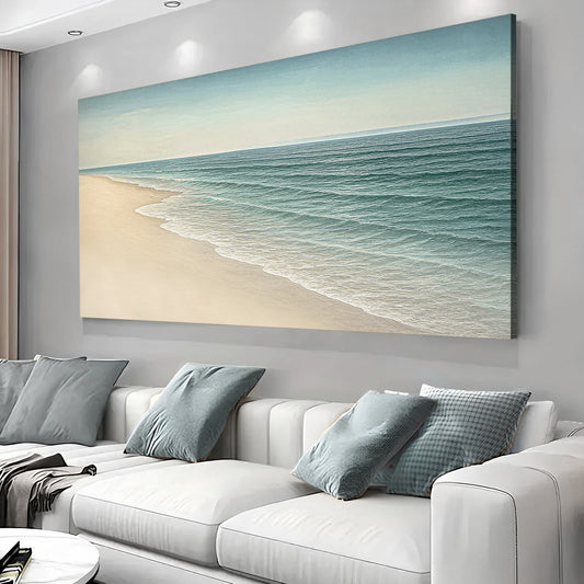 Landscape wall art canvas showing a sandy beach and calm ocean waves in teal and beige.