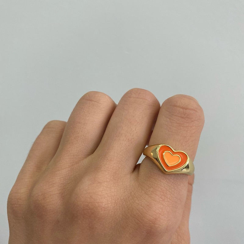 Love heart ring with orange enamel heart on gold-tone band with heart border
