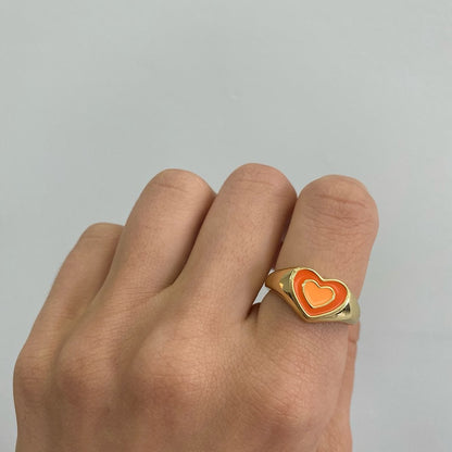 Love heart ring with orange enamel heart on gold-tone band with heart border