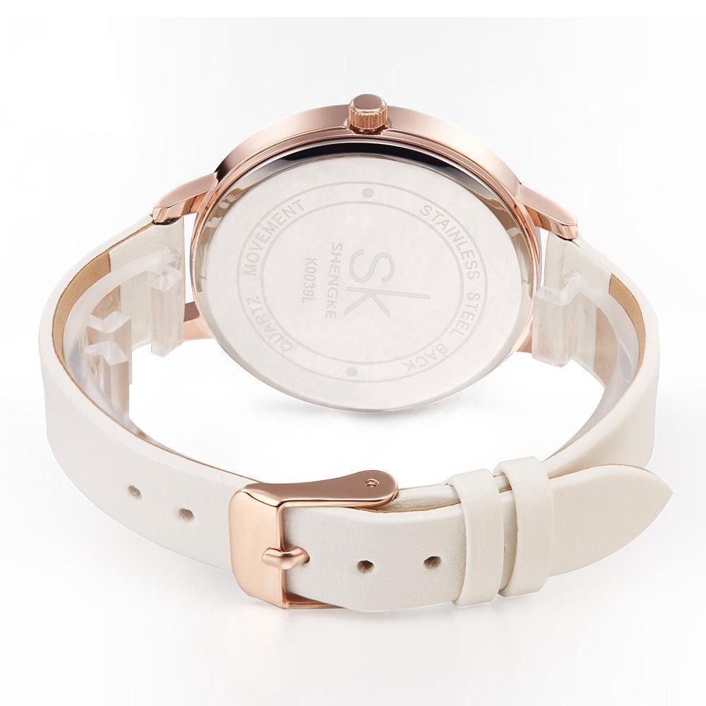 Shengke women's fashion watch with white leather strap and rose-gold case, clasp visible
