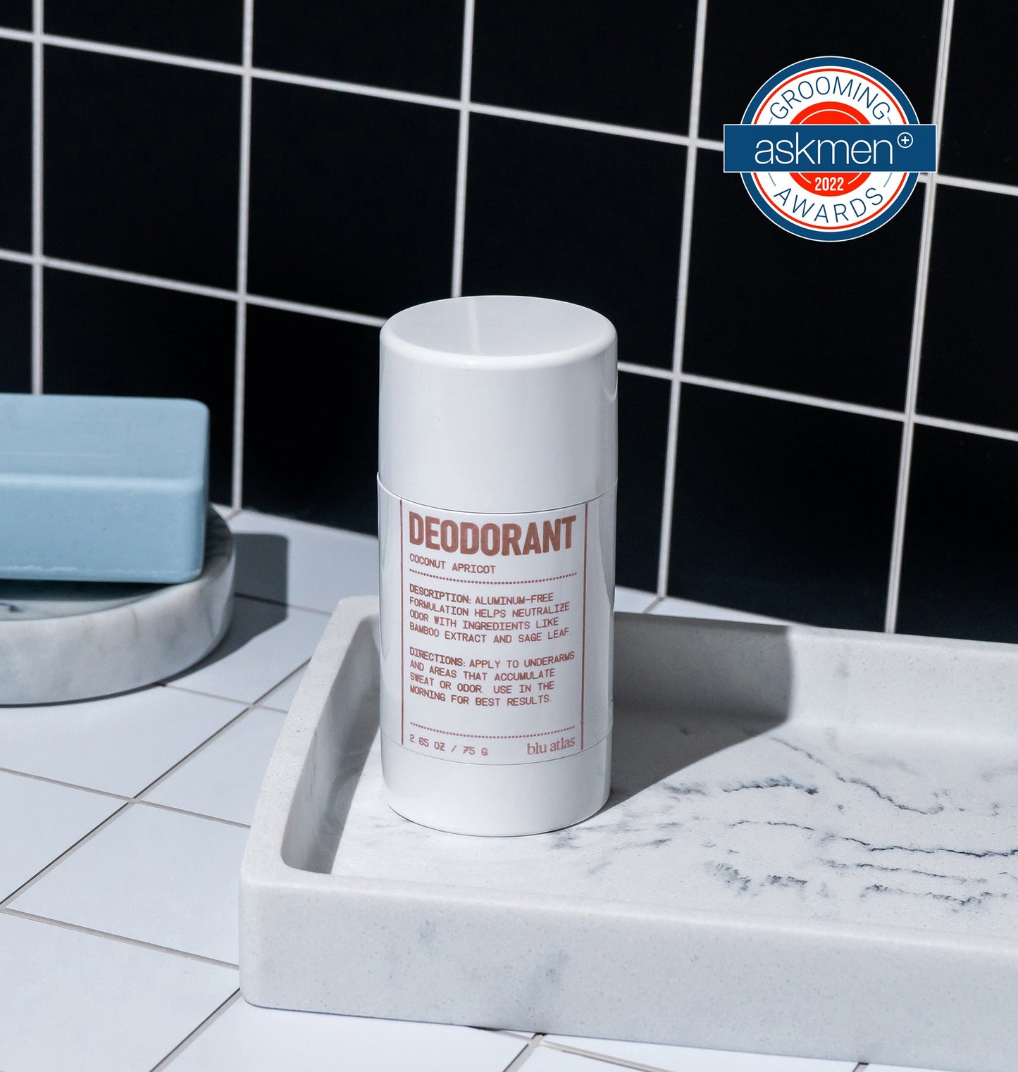 Deodorant stick container, white cylinder on soap tray with label facing up