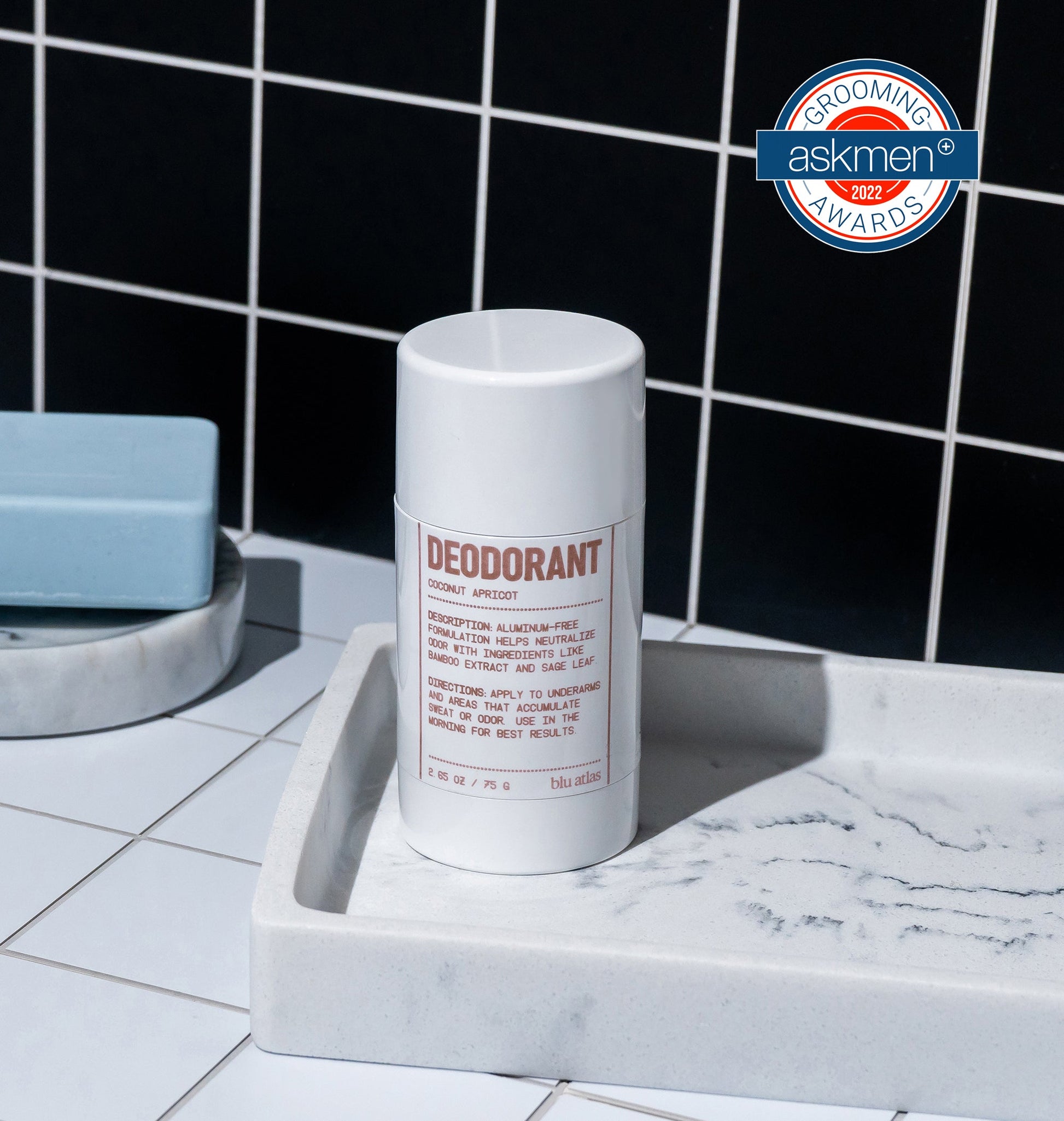 Deodorant stick container, white cylinder on soap tray with label facing up