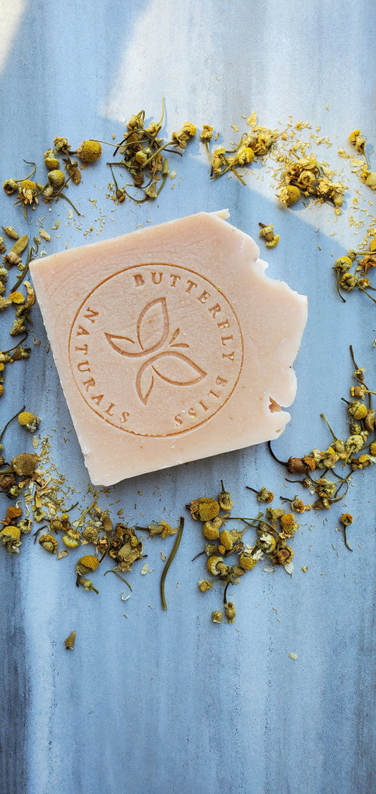 Shea butter soap bar with embossed leaf emblem, light beige
