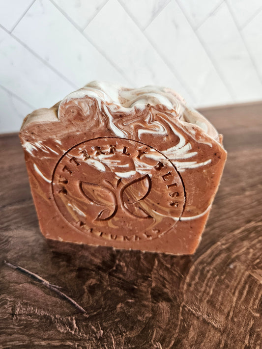 Cedarwood & Patchouli soap bar, brown with embossed circular logo on top