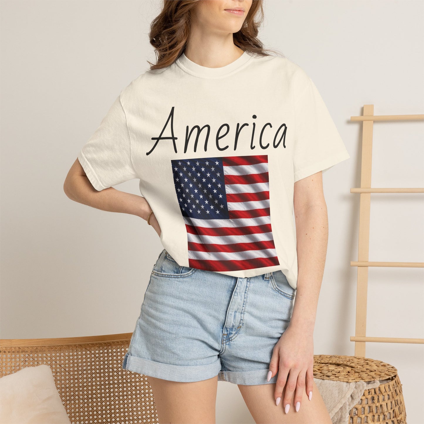 Unisex graphic T-shirt, off-white with “America” script and U.S. flag print