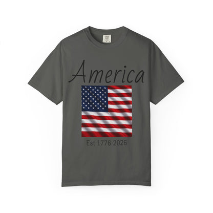 Dark gray unisex t-shirt with “America” script, US flag graphic, and “Est 1776-2026”