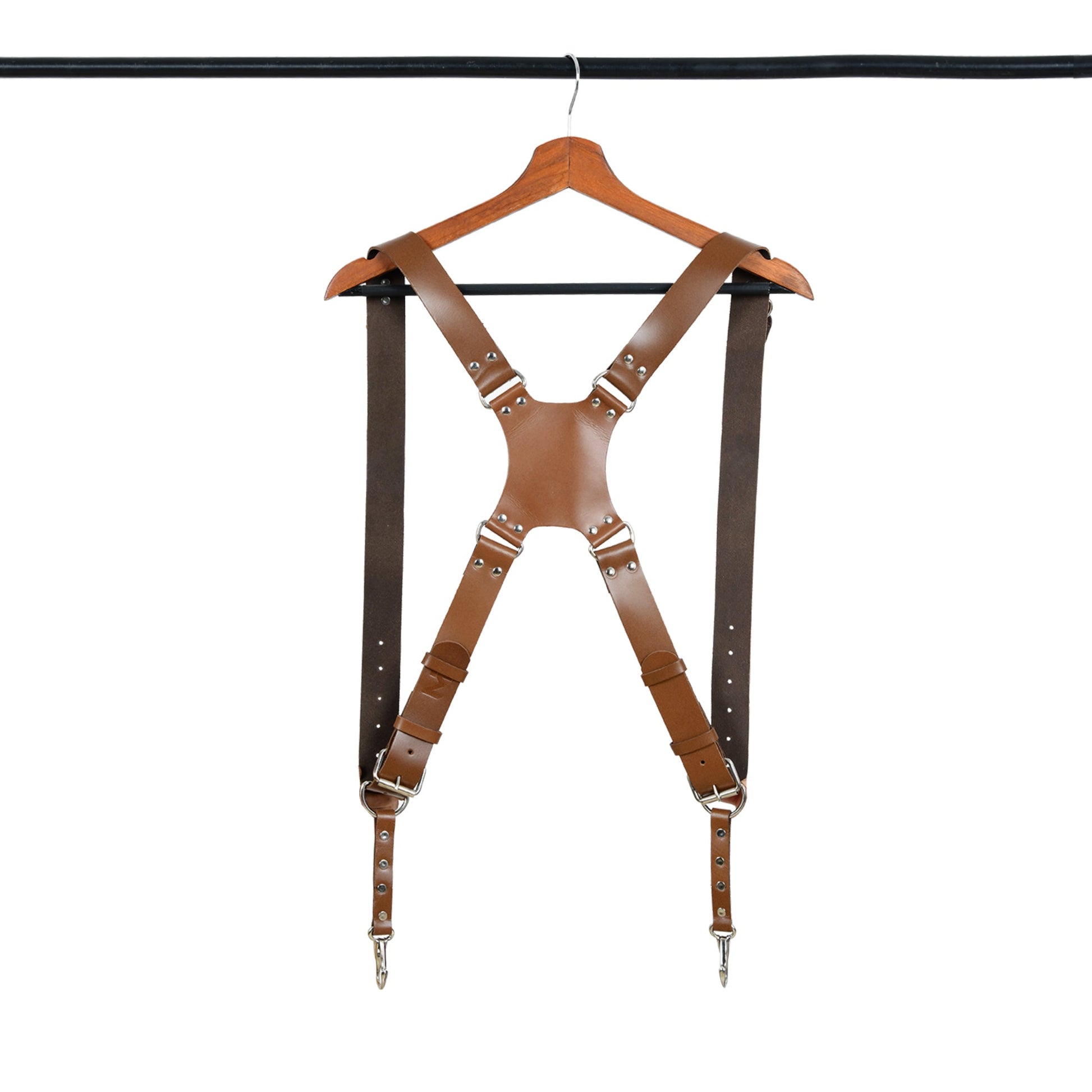Brown leather double-strap camera harness with metal D-rings and hanging clips