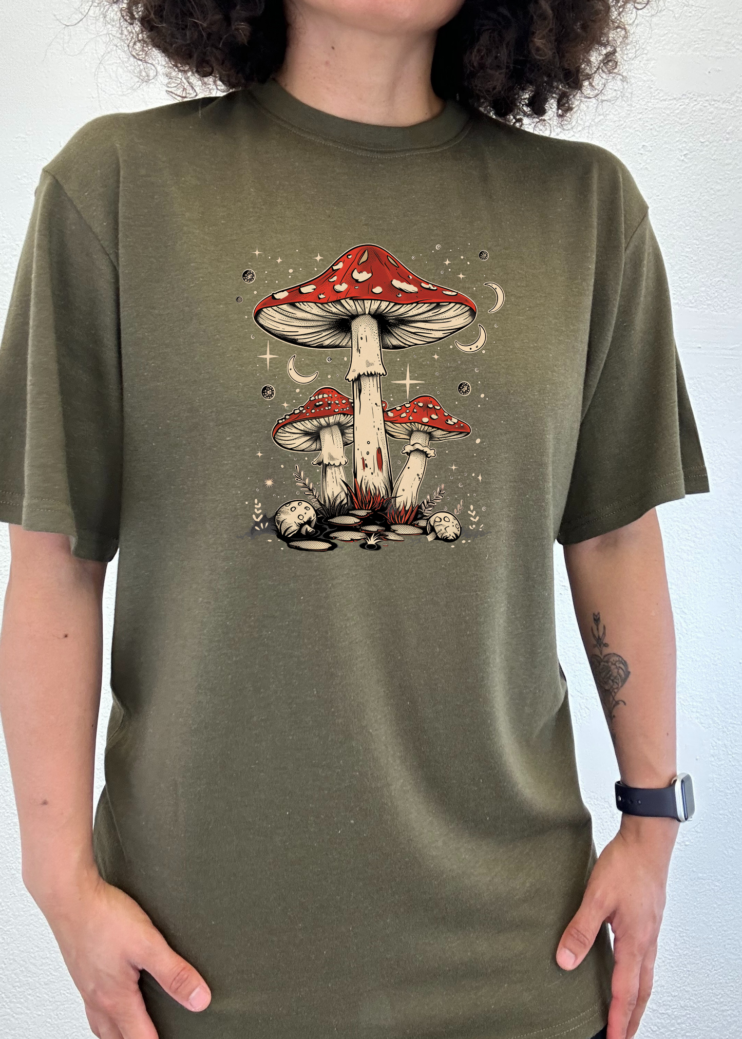Unisex graphic t-shirt in olive green with red mushroom artwork centered