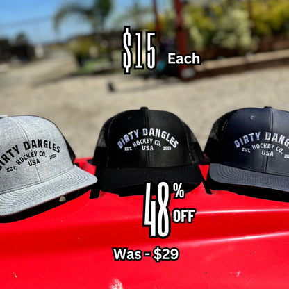 Three baseball caps with embroidered hockey logos on red car hood